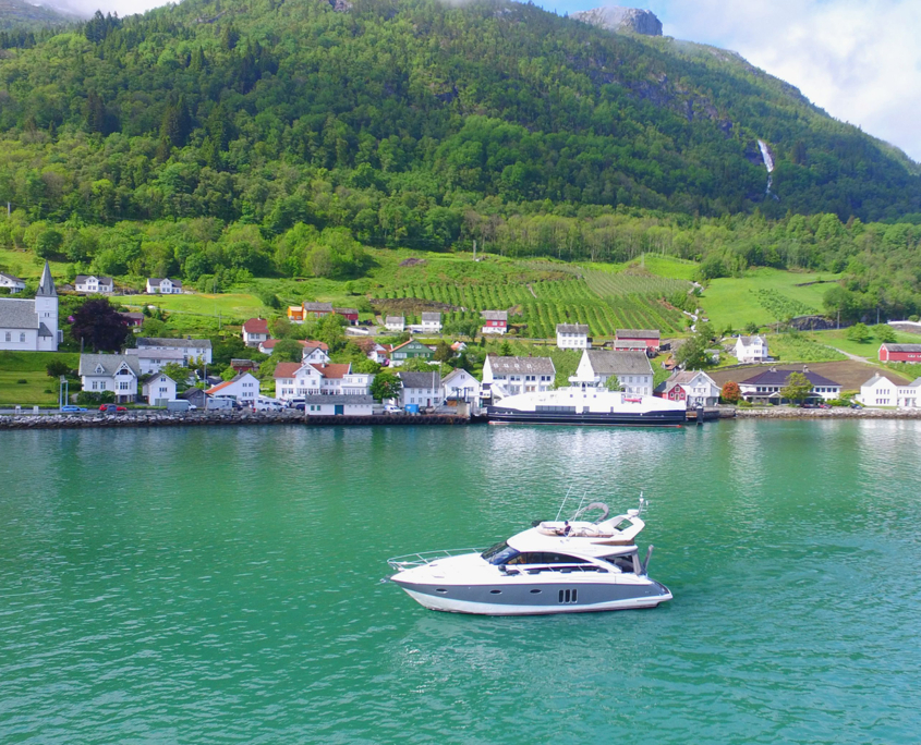 Hardanger01 A drone view of Utne in the Hardangerfjord, with the private cruise yacht "Iselina Bella M/Y" in front.
